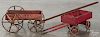 Two painted wood child's pull wagons, retaining a red surface, one stenciled Daisy, 15'' l.
