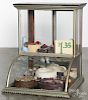 Country store nickel-plated counter top showcase, ca. 1900, filled with faux cakes and pies, 29'' h.
