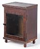 Small mahogany display cabinet, early 19th c., with a single pane door, 11 1/4'' h., 8 1/2'' w.