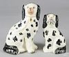 Two Staffordshire spaniels, one with a basket of flowers, 9 1/2'' h. and 8'' h.