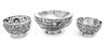 A Group of Three Chinese Silver Bowls, Various Makers, the largest bowl worked to show a writhing dragon among clouds, the two c