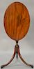 Duncan Phyfe mahogany candlestand having oval top on turned shaft with urn set on three downswept members ending in claw and ball fe...