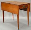 Federal cherry Pembroke drop leaf table with drawer having line, fan and panel inlays, circa 1790, (top cracked and legs ended out)....