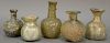 Five Roman glass flasks including sprinkler flasks and bottles, one pale green with iridescence, four with dimple or ribbed body, 2n...