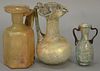 Three Roman glass jugs with handles including pale green, clear, and iridescent, 1st - 5th century A.D. ht. 3 1/4in. - 4 3/4in.
