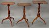 Three Federal cherry candlestands with shaped tops. ht. 27in., 28 1/2in., & 29 1/2in.