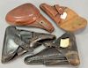 Group of four holsters including two German WWII leather pistol PPK holsters, a tan leather German, and a WWII Japanese clamshell le...