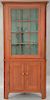 Corner cabinet in two parts, upper section with cornice molded top over single door with twelve glazed glass panels on lower section...