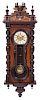A Victorian Walnut Regulator Clock Height 44 1/4 x width 18 1/2 inches.