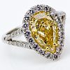EGL Certified 2.01 Carat Pear Shape Fancy Intense Yellow Diamond and Platinum Ring accented with .71 Carat Round Brilliant Cut Diamonds
