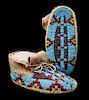 A Pair of Sioux Fully Beaded Child's Moccasins Length 6 inches.