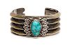 A Navajo Sand-Cast Coin Silver and Turquoise Cuff Bracelet, Perry Shorty Length 5 3/8 x opening 1 1/8 x width 1 1/8 inches.