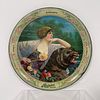 Rainier Beer Tin Tray, Lithographed circular tin tray "Strength, Purity, Vigor", featuring an image of a woman and a bear. Circa early 1900s. 13" diam