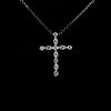 Diamond and 18k white gold cross pendant necklace.