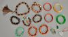 Group of Oriental jewelry to include eight hardwood and resin and hardstone beaded bracelets, jadeight bracelet, two cinnabar style ...