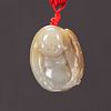 A Carved White Jade Pendant of a Buddha
