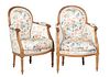 Pair of Louis XVI Style Carved Beech Bergeres, 20th c., the arched upholstered back to curved reeded upholstered arms, to a removable bowed cushion se