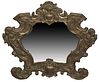 French Brass Repousse Mirror, 19th c., with a shell crest over a frieze with winged putti corners, to scrolled legs and a central medallion inscribed 