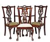 Set of Four Chippendale Style Carved Mahogany Dining Chairs, 20th c., consisting of two armchairs and two side chairs, the arched back over vertical i