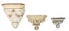 Group of Three French Louis XVI Polychromed Plaster Wall Brackets, early 20th c., with stepped hexagonal tops over relief fruit and floral supports, H
