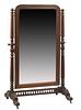 French Carved Oak Cheval Mirror, c. 1870, the arched relief carved lappet frame, around an ached plate, on turned tapered finial topped supports, to l