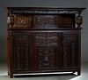 French Renaissance Style Carved Oak Buffet a Deux Corps, 19th c., the stepped ogee crown over a center cupboard door with iron strap hinges and escutc