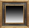 American Gilt and Gesso Mirror, the cove molded frame with ebonized sides, the corners with geometric tracery designs, around a wide beveled plate, H.