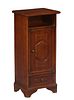 French Provincial Louis Philippe Style Carved Cherry Nightstand, 20th c., the rounded edge top over open storage, a long cupboard door and a bottom fr