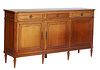 French Louis XVI Style Carved Cherry Sideboard, 20th c., the rectangular cookie corner top over three frieze drawers separated by reeded pilasters, ab