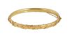 English 15K Yellow Gold Decorated Hinged Bangle Bracelet, c. 1900, with a relief twisted rope and floral decorated top, with a safety chain, H.- 3/16 