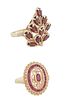Two Lady's 14K Yellow Gold Dinner Rings, one with an oval ruby atop a pierced band and an outer border of small round diamonds, Size 9; together with 