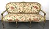 A Louis XV Giltwood Floral Upholstered Settee