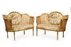A pair of French caned settees