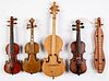 Four miniature violins and a dulcimer