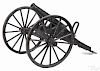 Cast iron cannon with a 1 1/4'' bore, mounted to a painted wood carriage with wood spoke wheels,