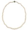 A CULTURED PEARL NECKLACE WITH AN 18 CARAT WHITE GOLD EMERALD AND DIAMOND CLASP