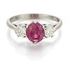 AN 18 CARAT WHITE GOLD RUBY AND DIAMOND THREE STONE RING