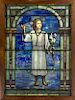 Tiffany Studios, a stained glass window depicting an angel under a columned arch holding lilies