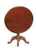 French Provincial Tilt Top Carved Walnut Center Table, c. 1880, the oval top on a turned tapered reeded urn support to quadruped scrolled legs, Closed