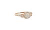 Lady's 18K Rose Gold Dinner Ring, with a central .5 carat round diamond, atop a border of tiny round diamonds, flanked by diamond mounted lugs and sho