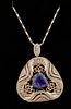 14K Yellow Gold Pendant, of pierced triangular form, with a trillion cut 3.87 ct. tanzanite within a swirled diamond mounted border, with a diamond mo