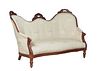 French Louis Philippe Style Carved Walnut Settee, late 19th c., the serpentine crest rail with three floral carved crests over an upholstered back, up