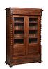 French Louis Philippe Carved Walnut Bookcase, 19th c., the stepped ogee crown over an incised frieze above set back double doors with glazed upper pan