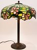 AMERICAN LEADED GLASS TABLE LAMP ON PATINATED METAL BASE C. 1920 - 1940 H 23.5" DIA 16.25" 