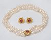 THREE STRAND PEARL NECKLACE WITH GOLD AND RUBY CLASP AND A PAIR OF MATCHING 14K GOLD AND RUBY EARRINGS