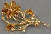 14K gold brooch with amber color stones in form of flower.