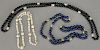 Three necklaces including a necklace with small pearls, one lapis, and one black onyx.