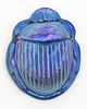An Iridescent Glass Scarab, Length 4 1/2 inches.