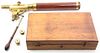 * A Brass and Mahogany Telescope, Width of case 18 inches.