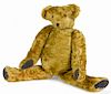 Early jointed teddy bear with elongated limbs, leather pads, and a hump, 18'' h.